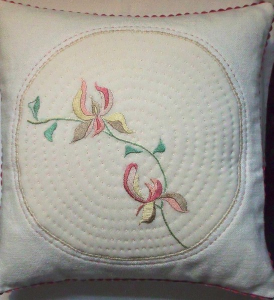 Cushion with stylised magnolia: hand embroidery