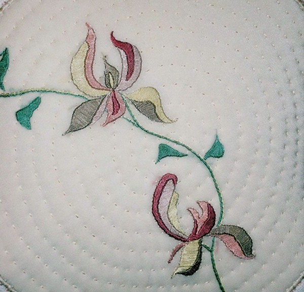 Cushion showing detail of stylised magnolia (hand embroidered)