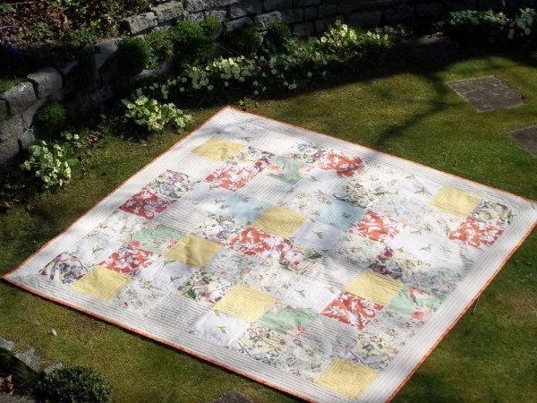 Primroses and patchwork quilt in spring colours