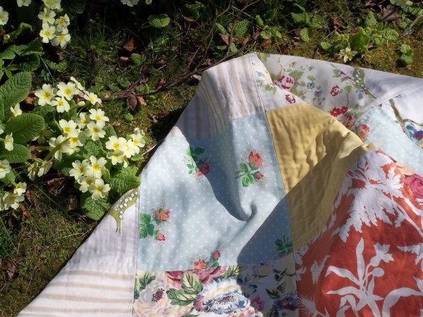 Patchwork quilt and primroses