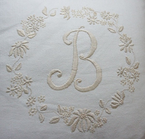 Linen union cushion, initial 'B' and daisies embroidered in ecru embroidery cotton.