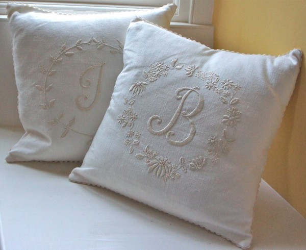 Pair of linen union cushions hand embroidered in ecru with initials, daisies and leaves