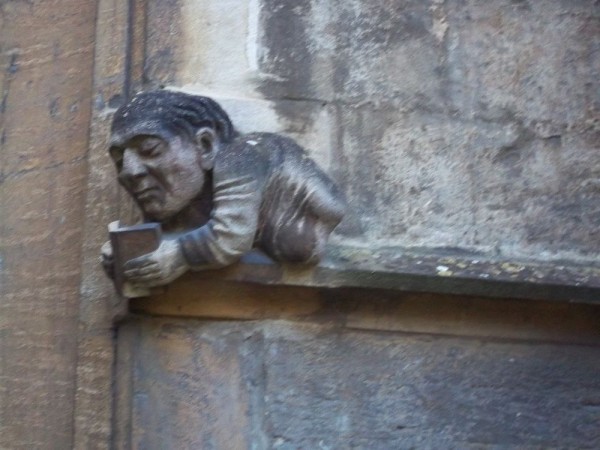 Grotesque on the outside of Balliol College Library showing the self absorption of reading