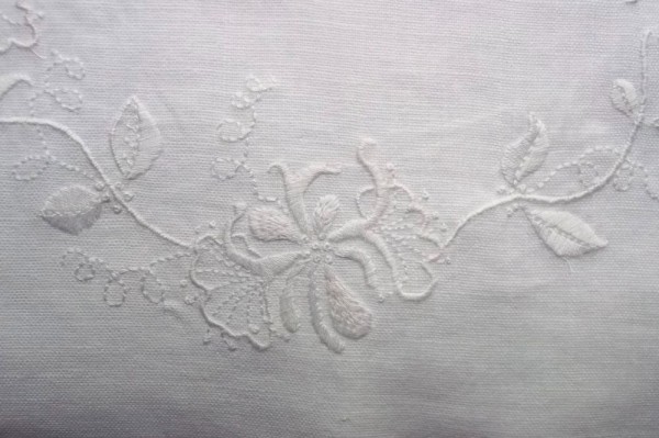 Whitework:  detail of hand embroidered  honeysuckle cushion