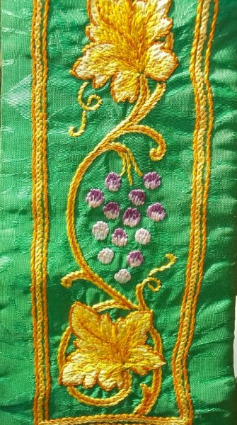 Green ecclesiastical stole: details of hand embroidered vine leaves and grapes