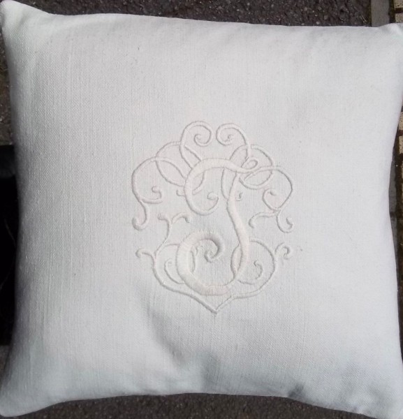 Whitework cushion with embroidered monogram