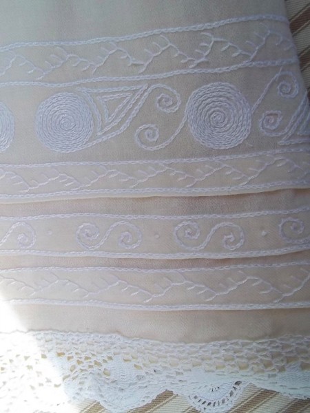 Christening dress in English Smock Embroidery: detail of concentric circles (wheel shapes suggest the trades of carter or wagoner.)