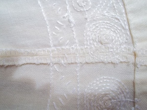 Christening dress: seam neatening with buttonhole stitch - not so neat but necessary when no sewing machine is available