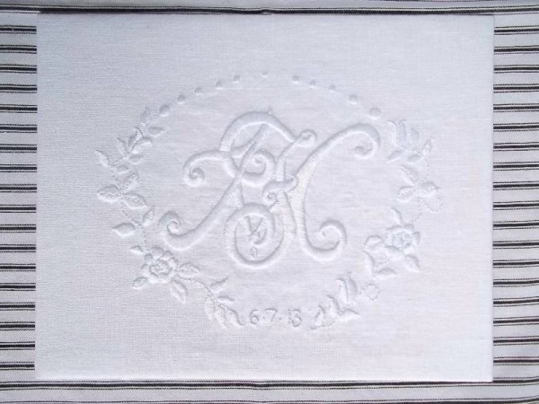 Wedding monogram: white embroidery cotton on white linen. Double monogram of F & M