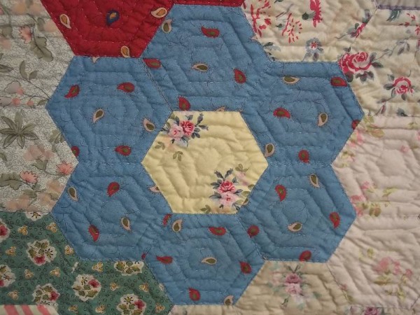 Grandmother's garden quilt: detail of hexagon patches showing Souleiado and Laura Ashley fabrics