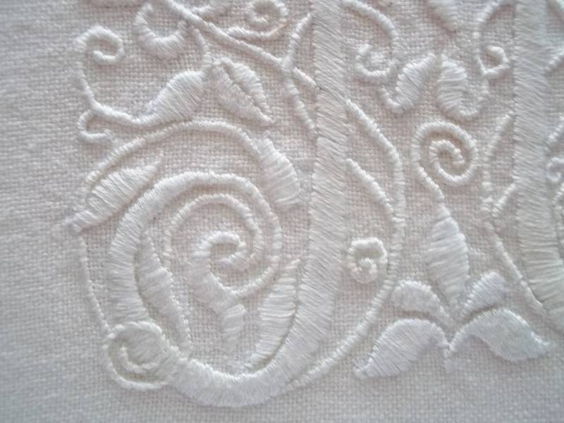 Whitework M: detail of hand embroidery in white embroidery cotton on white linen (Mary Addison)