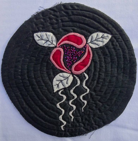 Circle of black silk with hand embroidered rose
