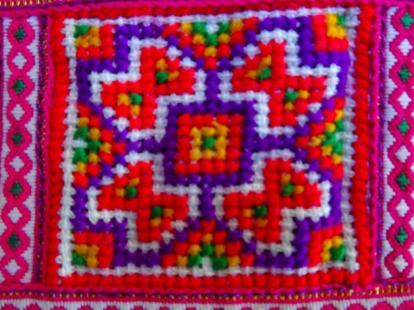 Detail of modern Vietnamese purse showing cross stitch panel.  Though the dyes look to be synthetic rather than natural,, the workmanship is still excellent.