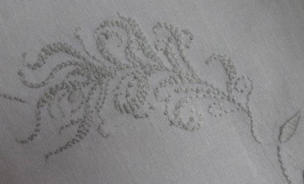 Embroidered feather/frond; hand embroidered on cushion with monogram M