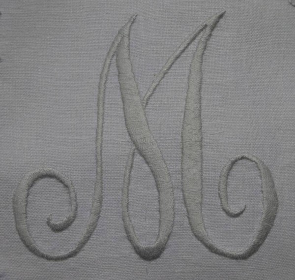 Hand embroidered  cushion: detail of  monogram M