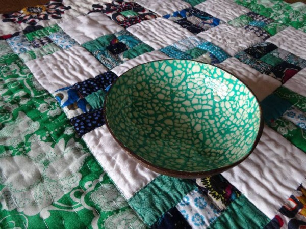 Vietnamese shell bowl on baby quilt of Vietnamese fabrics