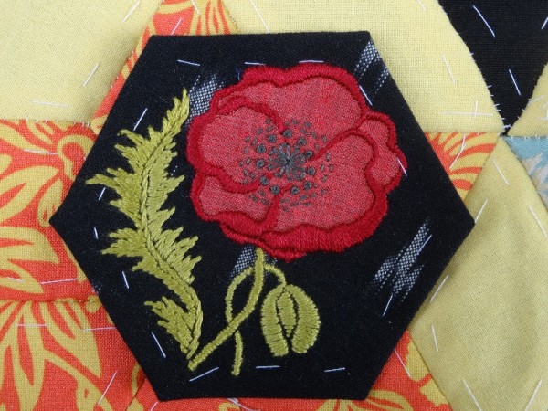 Patchwork hexagon with embroidered poppy (with grey stamens)