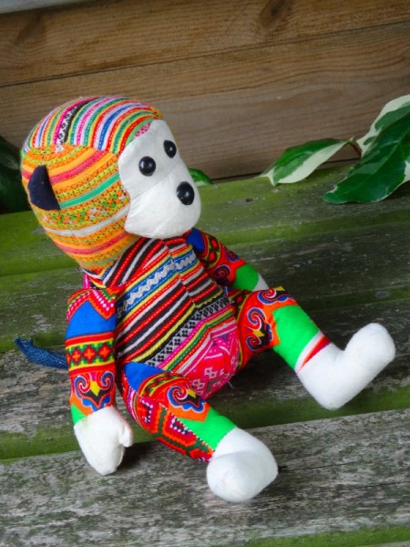 Hand crafted Vietnamese monkey made from modern fabric and vintage cross stitch embroidery.