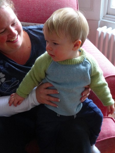 Nanny with baby wearing Debbie Bliss's design for a 2 colour raglan sweater 