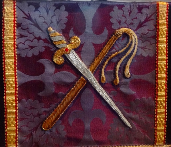 Purple altar frontal: symbols of the crucifixion, sword & whip (North Stoke Church, Oxon.)