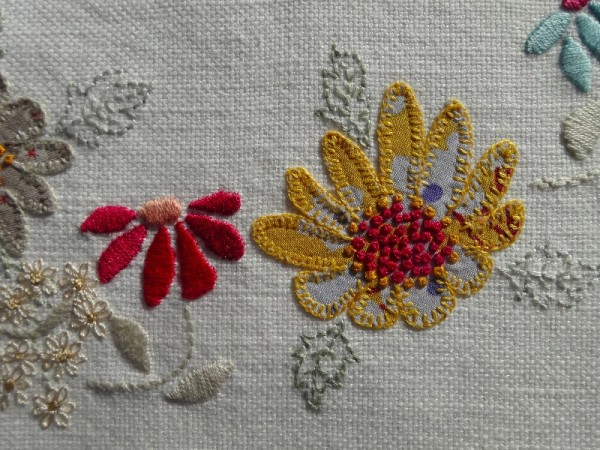 M monogram: detail of hand embroidered & appliquéd flowers 