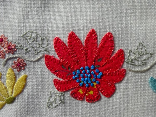 M monogram: detail of hand embroidered & appliquéd flowers 