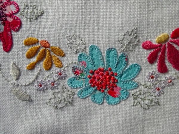 M monogram: detail of hand embroidered & appliquéd flowers 
