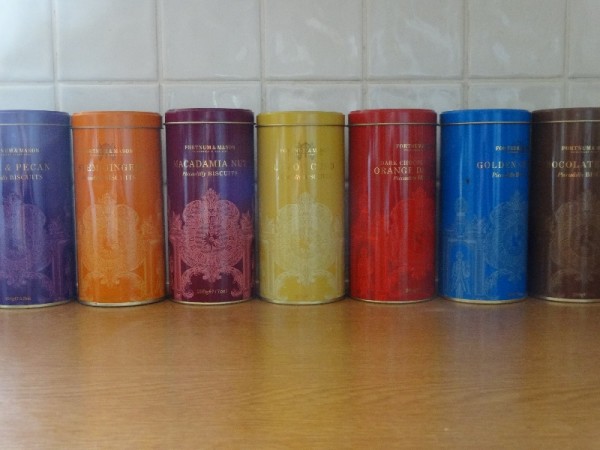 A line of Fortnum and Mason biscuit tins