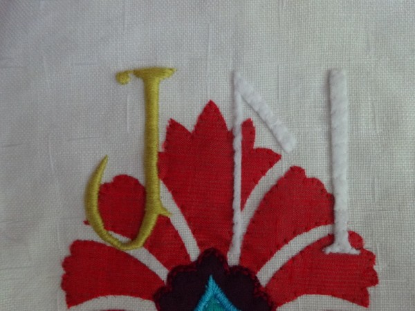 JM monogram in suzani style : Stage 2 where felt letter is slip stitched to fabric