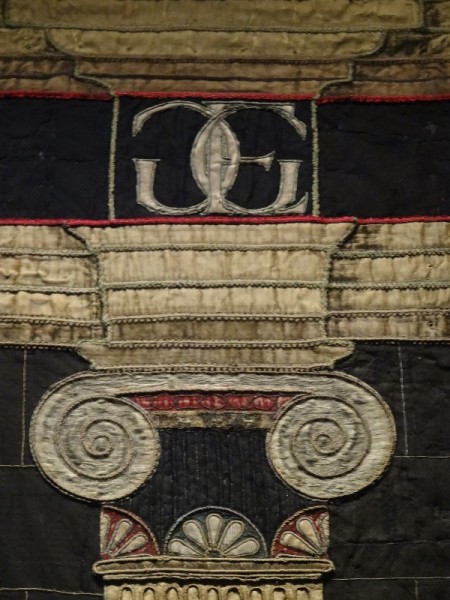 The Penelope hanging from   Hardwick Hall: detail showing pillar capital and monogram