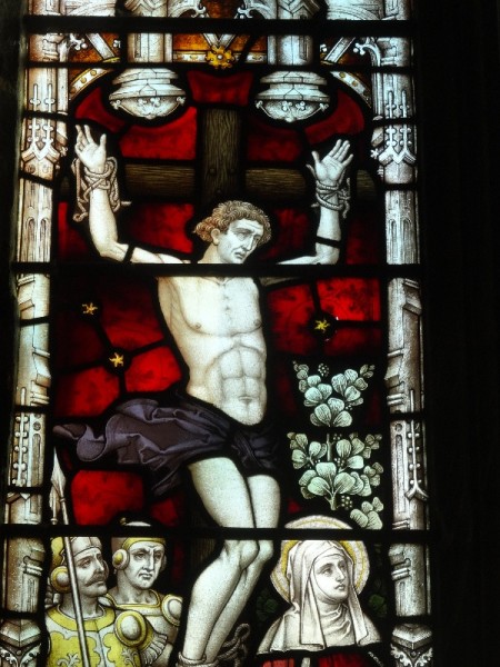 Ipsden Church: detail of east window showing one of the 2 robbers crucified along with Christ