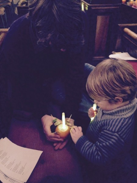 Grandson and son-in-law assembling a Christingle