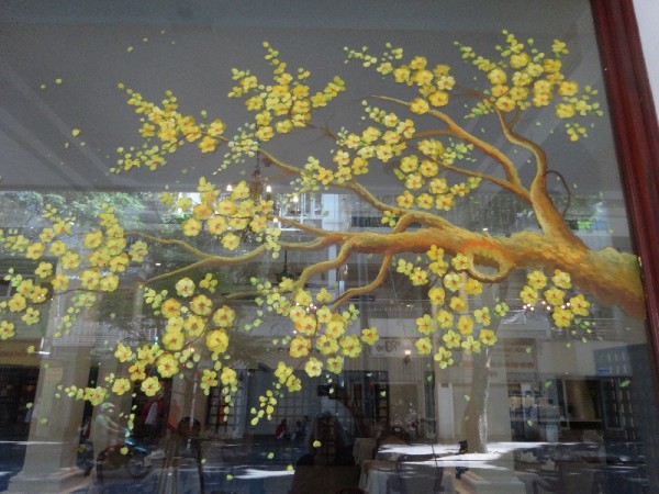 Shop window in Saigon (Ho Chi Minh City) with Tet decorations - a painted apricot branch